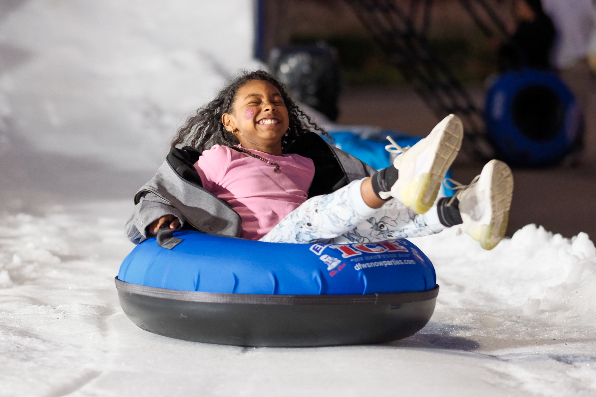 Kid sliding down snow slide